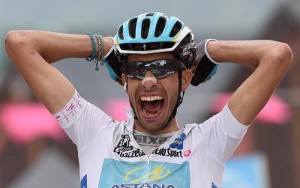 Italian rider Fabio Aru of the Astana Pro team celebrates as he crosses the finish line to win the 20th stage of the 98th Giro d'Italia