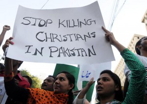 Pakistani Christian women hold a banner during a protest one day after Lahore churches attack, in Karachi