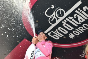 Autralian cyclist Simon Gerrans of Orica-Greenedge team celelbrate on the podium with the pink jersey after setting the best time in the 1st stage team time at the "Giro d'Italia" cycling race in Sanremo, Italy, 09 May 2015. ANSA/DANIEL DAL ZENNARO