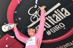 Autralian cyclist Simon Gerrans of Orica-Greenedge team celelbrate on the podium with the pink jersey after setting the best time in the 1st stage team time at the "Giro d'Italia" cycling race in Sanremo, Italy, 09 May 2015. ANSA/DANIEL DAL ZENNARO