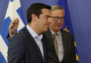 European Commission President Jean-Claude Juncker (R) welcomes Greek Prime Minister Alexis Tsipras (L)
