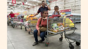 People line up to pay inside a Makro supermarket in Caracas