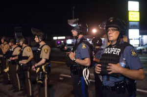 Officers from the Missouri State Highway Patrol and St. Louis County Police, wearing riot gear, guard the perimeter of the scene of an officer-involved shooting on West Florissant Avenue in Ferguson, Missouri, USA, 10 August 2015.  EPA/SID HASTINGS