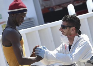 A migrants is helped disembark from Italian Coast Guard ship Diciotti at the Messina harbor in Sicily, Italy, Saturday, Aug. 29, 2015.  (ANSA/AP Photo/Carmelo Imbesi)