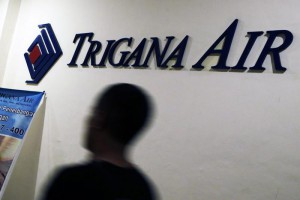 A Trigana Air employee walks passes the logo of Trigana Air at the main office, in Jakarta, Indonesia, 16 August 2015. EPA/MAST IRHAM