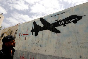 A Yemeni man looks at graffiti showing a US drone after al-Qaeda in Yemen confirmed the death of its leader in US drone strike, in Sana'a, Yemen, 16 June 2015. EPA/YAHYA ARHAB