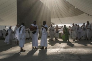 Muslim pilgrims walk after casting stones at a pillar symbolizing the stoning of Satan, in a ritual called "Jamarat," the last rite of the annual hajj, on the first day of Eid al-Adha, in Mina near the holy city of Mecca, Saudi Arabia, Thursday, Sept. 24, 2015. (ANSA/AP Photo/Mosa'ab Elshamy)