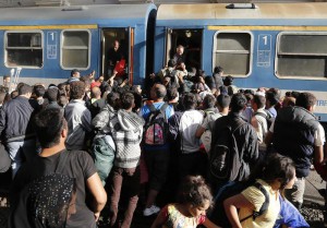 Migrants try to board a train at the railway station in Budapest, Hungary, Thursday, Sept. 3, 2015. (ANSA/AP Photo/Frank Augstein)