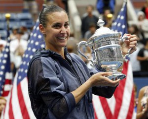 Flavia Pennetta, of Italy, holds up the championship trophy after beating Roberta Vinci, of Italy, in the women's championship match of the U.S. Open tennis tournament, Saturday, Sept. 12, 2015, in New York. (ANSA/AP Photo/Julio Cortez)