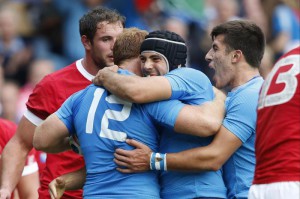 Italy's Gonzalo Garcia, centre left, celebrates scoring a try with teammates during the Rugby World Cup Pool D match between Italy and Canada at Elland Road, Leeds, England, Saturday, Sept. 26, 2015. (ANSA/AP Photo/Alastair Grant)