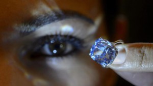 A Sotheby's employee displays the rare Blue Moon Diamond during a preview at the Sotheby's, in Geneva, Switzerland, 04 November 2015. EPA/MARTIAL TREZZINI