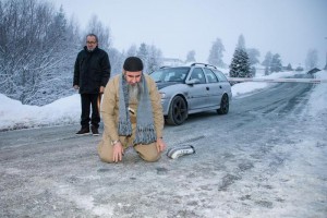 Najumuddin Faraj Ahmad (front), better known as Mullah Krekar, pictured praying on an icy road after he was released from Kongsvinger prison 25 January 2015, Kongsvinger, Norway.  EPA/AUDUN BRAASTAD NORWAY OUT