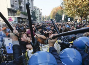 Police officers face students and school workers as they take part in a nation-wide protests against an Italian government's school reform, in Milan, Italy, Friday, Nov.13, 2015. (ANSA/AP Photo/Luca Bruno)