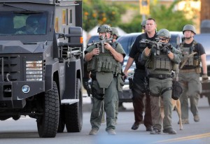 Authorities search an area Wednesday, Dec. 2, 2015, following a shooting that killed multiple people at a social services center for the disabled in San Bernardino, Calif. (James Quigg/The Victor Valley Daily Press via AP)