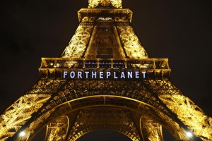 The slogan "FOR THE PLANET" is projected on the Eiffel Tower as part of the COP21, United Nations Climate Change Conference in Paris, France, Friday, Dec. 11, 2015.  (ANSA/AP Photo/Francois Mori)