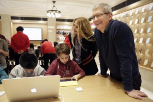 FILE - In this Wednesday, Dec. 9, 2015, file photo, Apple CEO Tim Cook, right, and Apple software engineer and Vice President Cheryl Thomas watch third grade students work on coding at an Apple Store, in New York. You really want kids to learn these building blocks as young as possible and then build on them, said Cook. (ANSA/AP Photo/Mark Lennihan, File)