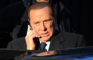 Silvio Berlusconi parla al telefono mentre sale in auto dalla sua abitazione nel centro di Milano in una foto d'archivio. ANSA/ DANIEL DAL ZENNARO