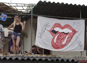 A girl stands on the roof of a house next to the Ciudad Deportiva to get a view of the Rolling Stones concert in Havana, Cuba, Friday March 25, 2016. The Stones are performing in a free concert in Havana Friday, becoming the most famous act to play Cuba since its 1959 revolution. (ANSA/AP Photo/Desmond Boylan)