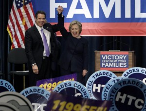 New York Governor Mario Cuomo (L) reacts next to US Democratic presidential candidate Hillary Clinton at the conclusion of his campaign for economic justice victory rally for $15 dollars a day minimum wage and paid family leave at the Jacob K. Javits Convention Center in New York, New York, USA, 04 April 2016. EPA/JASON SZENES