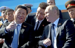 Russian President Vladimir Putin (R) and Chinese President Xi Jinping (L)  speak during the Victory Day Parade in the Red Square in Moscow, Russia, 09 May 2015. The Victory Day parade on 09 May 2015 marks the 70th anniversary since the capitulation of Nazi Germany.  EPA/HOST PHOTO AGENCY / RIA NOVOSTI POOL MANDATORY CREDIT