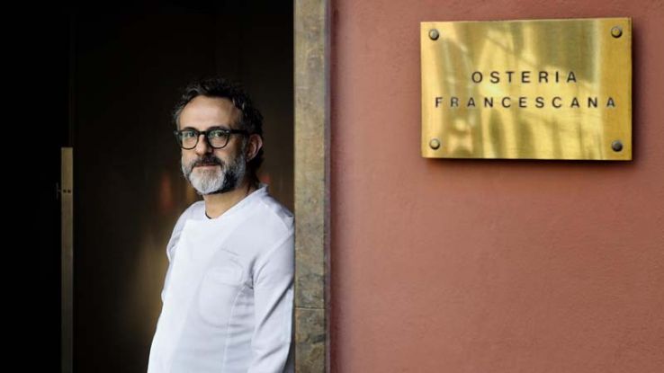 Massimo Bottura sulla soglia della sua Osteria Francescana a Modena.